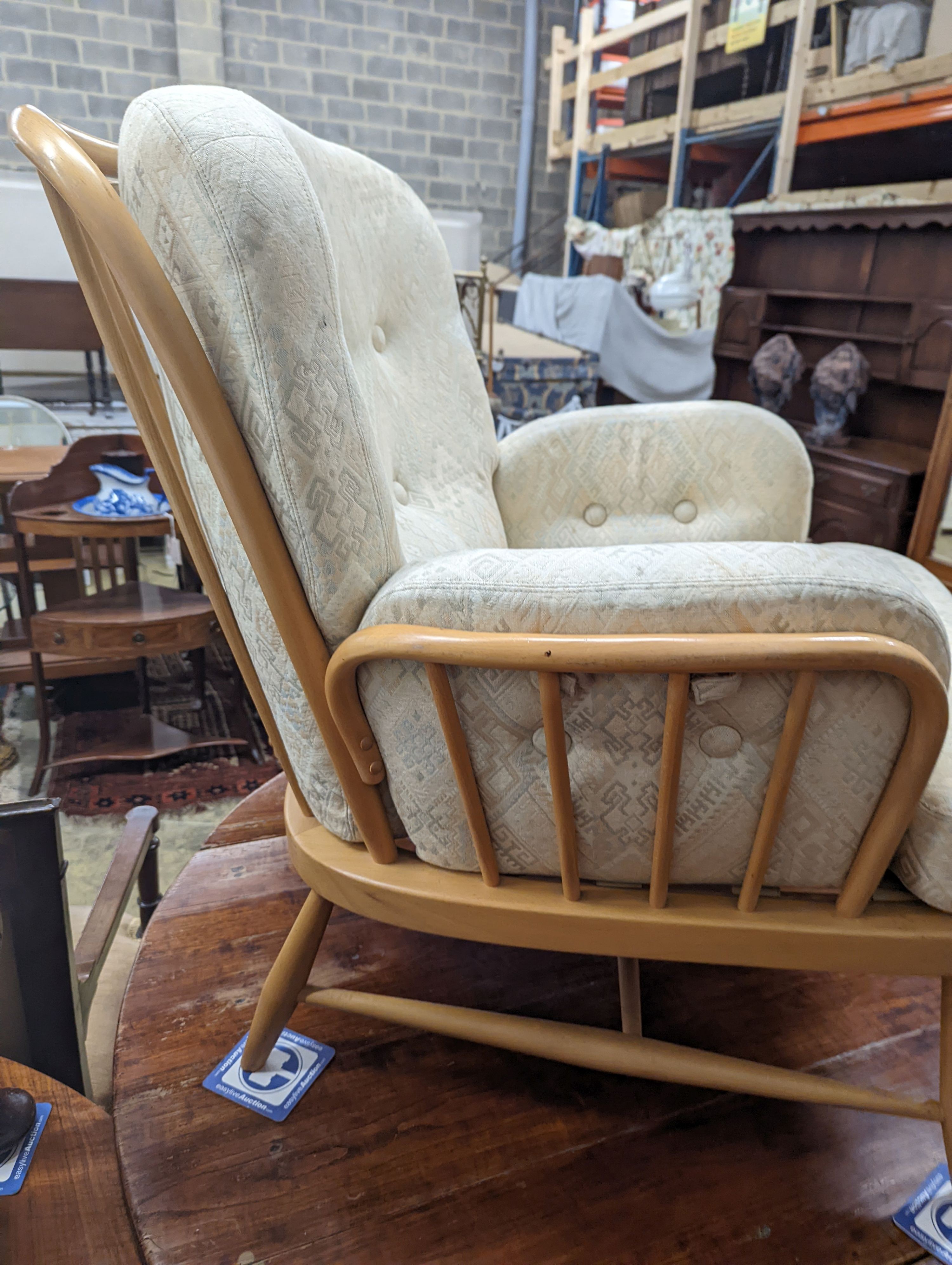 An Ercol Jubilee beech armchair with loose cushion upholstery, width 77cm, depth 80cm, height 86cm